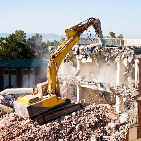 demolishing a building using an excavator courtland ms