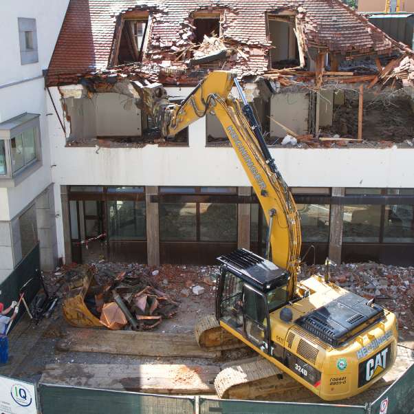 excavator demolishing building courtland ms