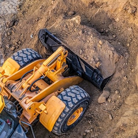 top view of excavator scooping ground dirt courtland ms